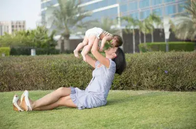 Dear New Parents, Quality Sleep is Possible with an Air Purifier : Woman playing with baby outside in clean air