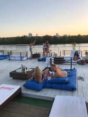 He Wants to See You in Your Bikini Because it’s Step One in a Relationship : Man with girlfriend in swimsuit surrounded by women in bikini