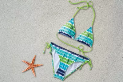 How to Ask Your Girlfriend to Model a Bikini : Bikini laying on the sand near a starfish