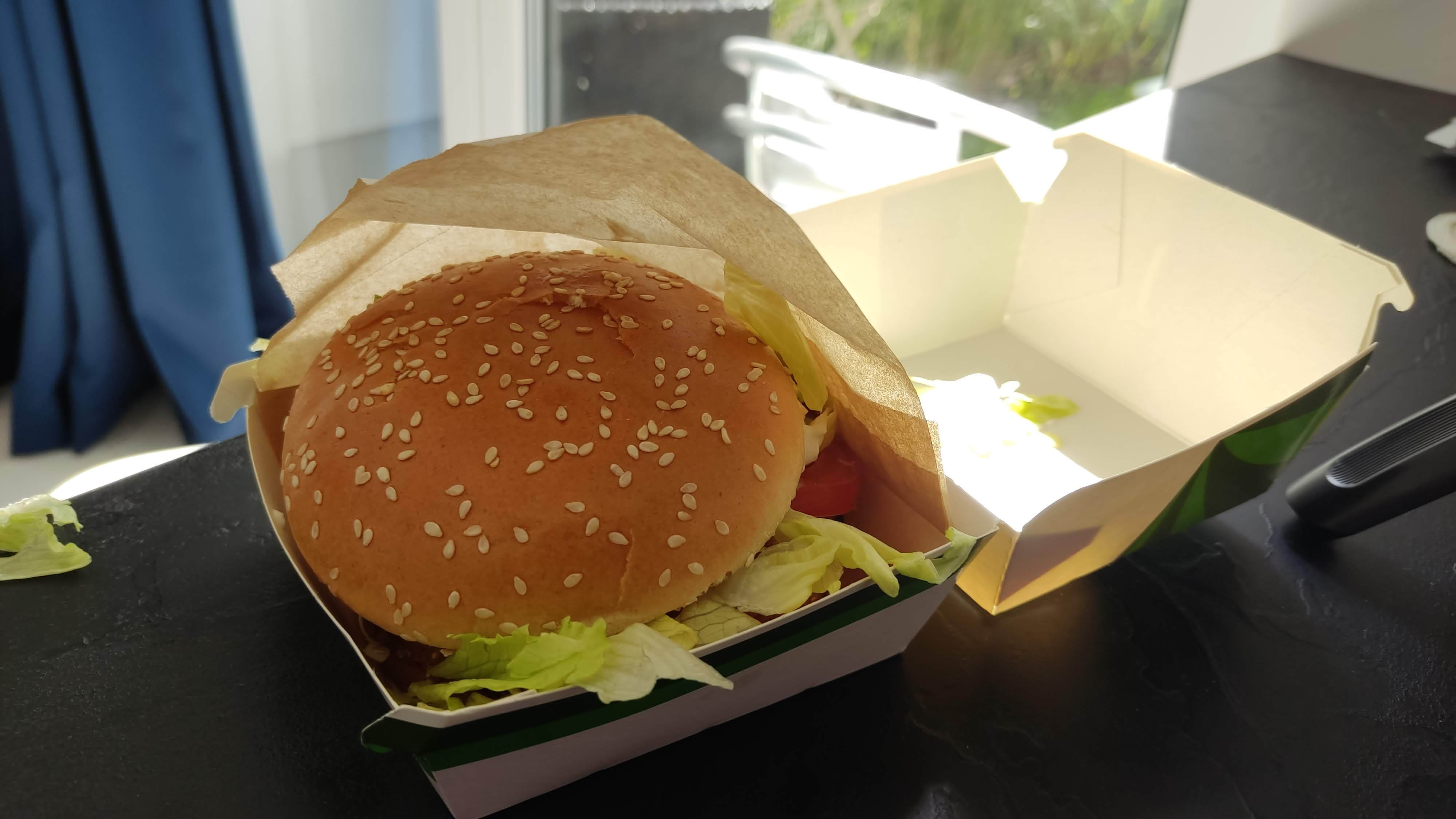 The McDonald's Veggie Burger: A Taste of Poland's Green Revolution : Veggie burger in its open carton box and presented in a paper wrap